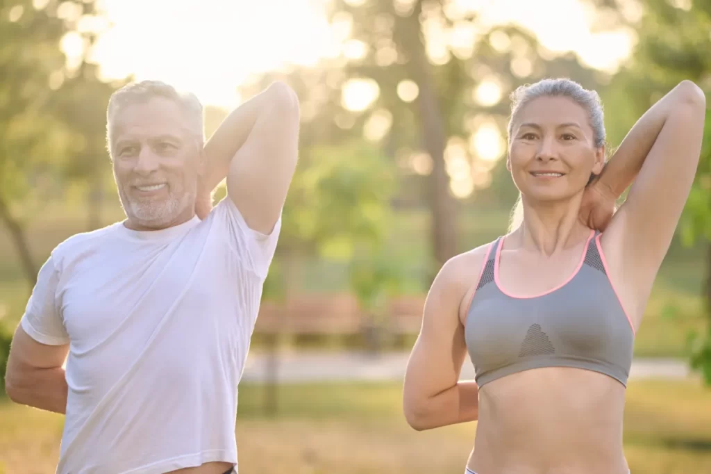 a mid aged couple stretching before the morning wo utc